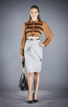 Photo of model wearing a horizonatally striped long-sleeve button-up with a high-waisted pencil skirt.