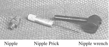 Photo of a nipple, nipple prick and nipple wrench.