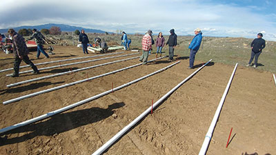 Figure 4. Photograph of people laying out the PVC pipes for the frame.