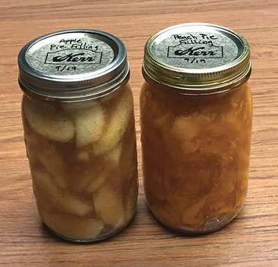 Photograph of two Mason jars of pie filling.