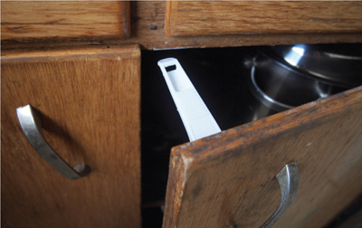 Fig 4. A childproof safety latch on a cabinet door.