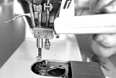 Photograph of placing a drop or two of oil on moving parts where they slide through a housing or move against each other.