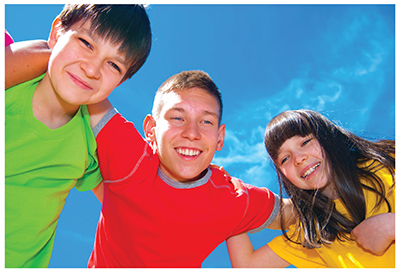 Photograph of three children dressed in T-shirts.