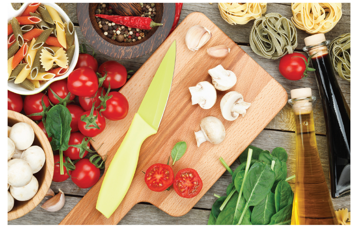 Cutting board with knife and some vegetables