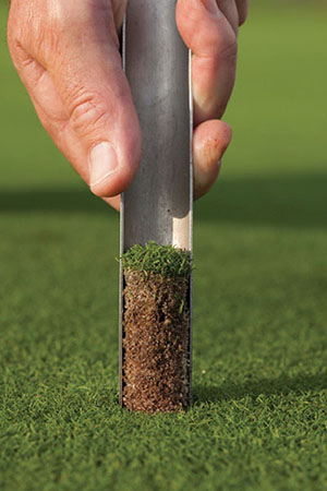 Photograph of using a soil probe to take a soil sample.