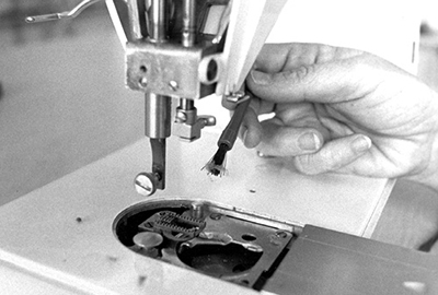 Photograph of removing the bobbin case to remove all lint and stray threads.