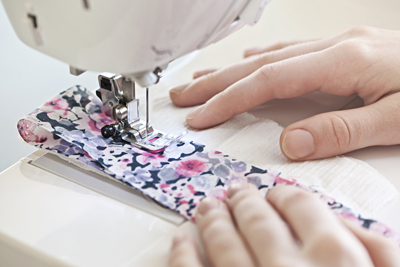 Photo of a machine stitching fabric. 