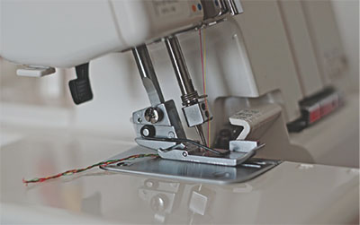 Photograph of the presser foot on an overlock machine.