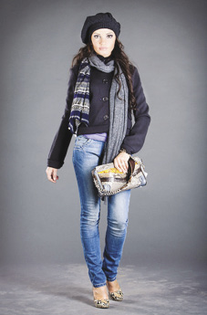Photo of model wearing loosefitted button-up jacket, scarf, and light wash skinny jeans.
