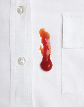 Photograph of ketchup on a white shirt.