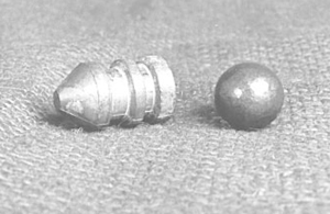 Photo of a round lead ball and conical slug.