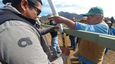 Figure 6: Photograph of people using an I-beam level to level the side braces.