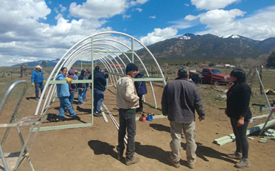 Figure 10: Photograph of people framing the end of the hoop house.