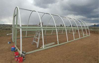 Figure 11: Photograph of the hoop house with PVC pipes and batten boards installed.