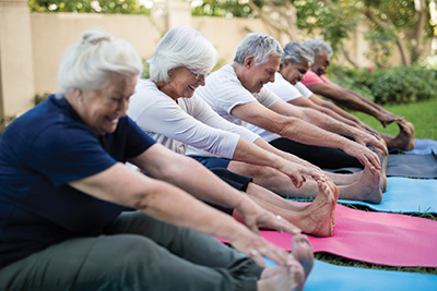 Photograph of a group of people stretching.