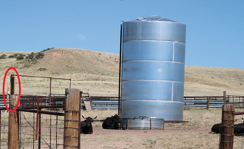 Photo of a water tank with the location of the SmaXtec base station circled in red.