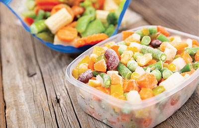 Photograph of frozen vegetables in a container.