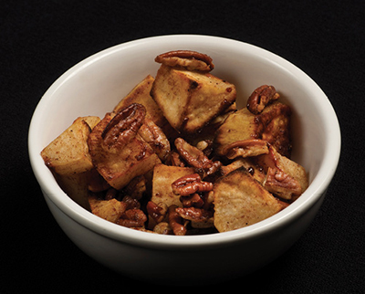 Photograph of roasted sweet potatoes with pecans.