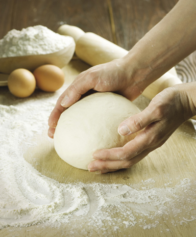 Photograph of bread dough being kneaded