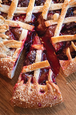 Photograph of a cherry pie with a lattice crust top.