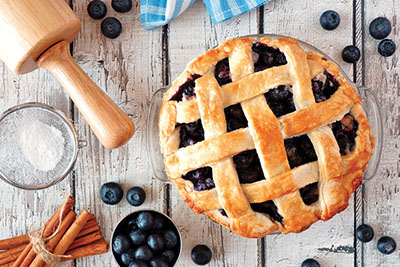 Photograph of a blueberry pie with a lattice crust top.