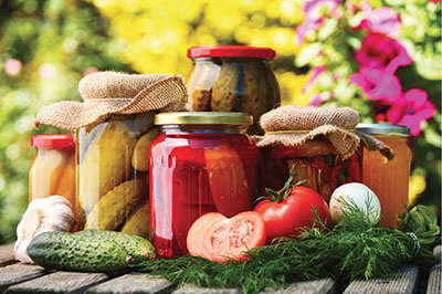 Photograph of jars of canned pickles.
