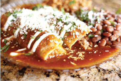 Photo of enchiladas smothered in red chile sauce.