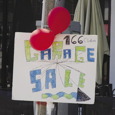 Photo of balloons and a colorful sign.