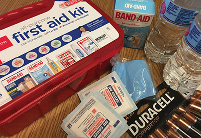 Photograph of a first aid kit and its contents.