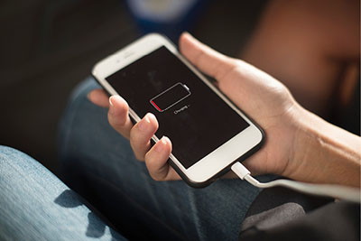 Photograph of a person holding a cell phone.