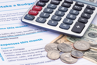 Photograph of a calculator and loose change.