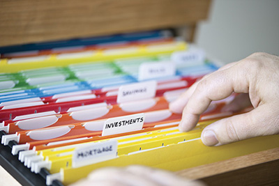 Photograph of a pair of hands and file folders.