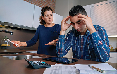 Photo of man and women arguing over bills