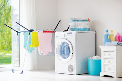 Photograph of a washing machine and clothes-drying rack.