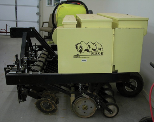 Photograph of a narrow-bodied, heavy seeder.