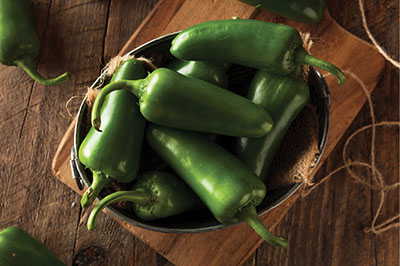 Photograph of green jalapeños in a bowl.