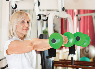 Diverse group of young people working out together with weights in