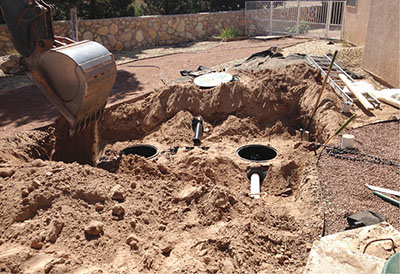 Photograph of a septic tank being buried in a yard