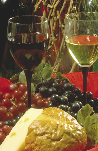 Photo of wine, grapes, and assorted cheeses.