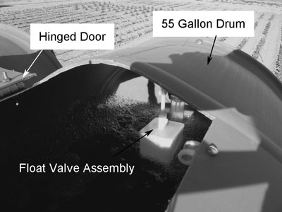 Fig. 12: Photograph showing hinged door cut into tank and float valve.