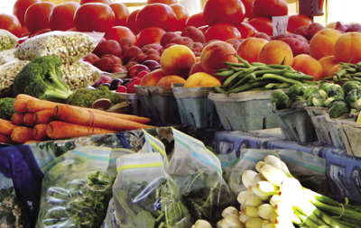 Photograph of a variety of produce at a farmers’ market.